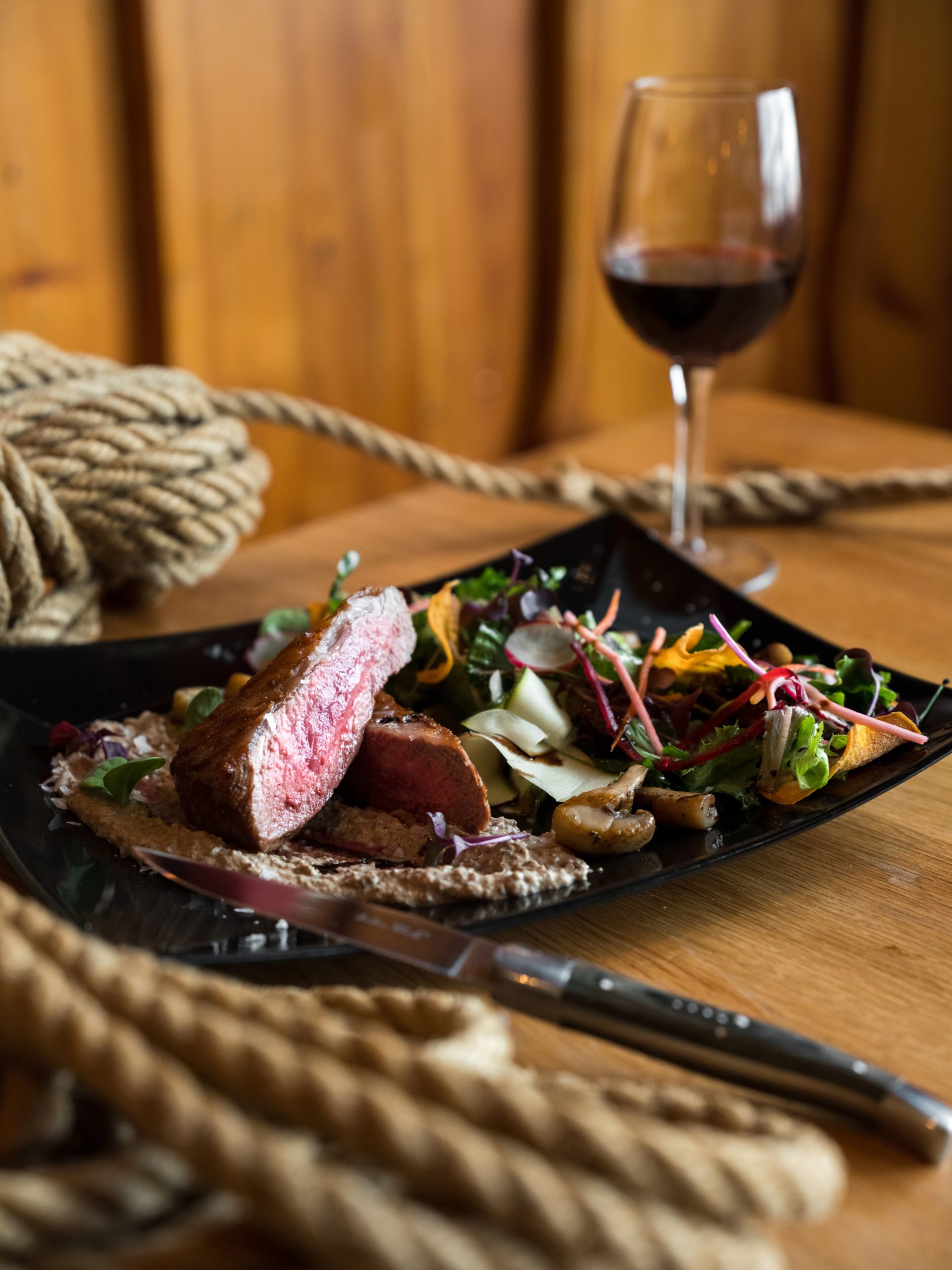 delicious-meat-steak-served-with-vegetable-salad-and-glass-4344579